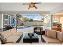 Inviting screened-in patio with comfortable seating overlooking a private pool and well-kept backyard at 826 Oak Briar Ln, Osprey, FL 34229