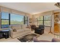 Cozy living room with large windows and a comfortable seating area, plus view at 8779 Midnight Pass Rd # 106H, Sarasota, FL 34242