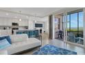 Open-concept living space with kitchen, island seating, and access to a screened-in porch with water view at 910 Tidewater Shores Loop # 107, Bradenton, FL 34208
