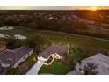 Aerial view of the property showing a golf course view, mature trees, and the home's tiled roof at 9408 Glen Abbey Ln, Sarasota, FL 34238