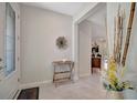 Stylish foyer with decorative accents, tiled floors, and an open view into the living spaces at 9928 Bright Water Dr, Englewood, FL 34223