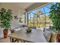 Inviting screened-in patio with comfortable seating, perfect for outdoor dining and relaxation at 9928 Bright Water Dr, Englewood, FL 34223