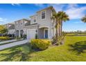 Charming home exterior with a blue front door, attached garage, and well-maintained landscaping at 8612 Lunar Skye St, Sarasota, FL 34241