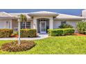 Inviting front entrance with well-manicured landscaping and charming architectural details at 1511 Waterford Dr, Venice, FL 34292