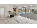 Light-filled sun room with view of pool through sliding glass doors to enclosed lanai at 1511 Waterford Dr, Venice, FL 34292