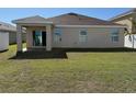 Large backyard featuring a covered patio and sliding glass doors at 15517 Rose Grove Dr, Bradenton, FL 34212
