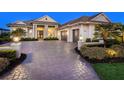 Beautiful paved driveway leading to a three-car garage of a well-maintained one-story home at 16407 Daysailor Trl, Lakewood Ranch, FL 34202