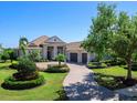 Beautiful one-story home boasting a tile roof, and a manicured front yard with lush landscaping at 16407 Daysailor Trl, Lakewood Ranch, FL 34202