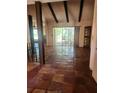 Spacious living room with a vaulted ceiling, exposed beams, and sliding glass doors at 1862 Orangewood Ln, Sarasota, FL 34232