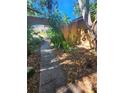 Arched walkway leading to a charming property with mature trees and landscaping at 1862 Orangewood Ln, Sarasota, FL 34232