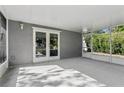 Enclosed patio perfect for enjoying outdoor space with French doors and screened walls at 2039 Kai Dr, Sarasota, FL 34231