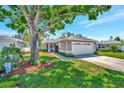 Attractive home with mature trees and a well-manicured lawn at 2407 Waterford Ct, Palmetto, FL 34221