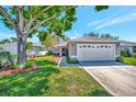 Inviting single-story home with a pristine lawn and attached garage at 2407 Waterford Ct, Palmetto, FL 34221