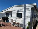 Close up of cozy home exterior showing the deck, grill, and outdoor seating area at 2601 Gulf N Dr # 214, Bradenton Beach, FL 34217