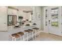 Modern kitchen with stainless steel appliances, granite countertops, and a breakfast bar with seating at 3169 Alba Cir, Bradenton, FL 34211