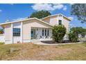 Charming two-story home featuring a welcoming blue front door and beautifully landscaped front yard at 4406 17Th W St, Palmetto, FL 34221