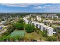 Expansive aerial shot of the community featuring well-manicured lawns, multiple buildings, and tennis courts at 4440 Ironwood Cir # 509D, Bradenton, FL 34209
