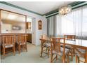 Cozy dining area with a chandelier, natural lighting, and seating for six at 4440 Ironwood Cir # 509D, Bradenton, FL 34209