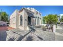 Attractive building with landscaped front yard including stone pavers, tiled roofing and wrought iron decor at 446 Burns Ct, Sarasota, FL 34236