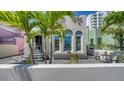 Charming home featuring unique architecture, beautiful windows, and lush landscaping at 446 Burns Ct, Sarasota, FL 34236
