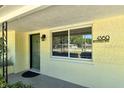 A view of the home's address plate, front door, and a planter near the entrance at 4560 Brooksdale Dr, Sarasota, FL 34232