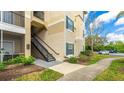 Well-maintained building exterior with stairs, manicured lawn, and convenient parking at 5160 Northridge Rd # 206, Sarasota, FL 34238