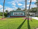 Adorable single story home with lush lawn and an easy access covered carport at 5910 Majestic Way, Palmetto, FL 34221