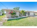 Lovely single-story home with stone accents, mature landscaping, and a well-kept lawn at 6387 Shalimar St, Port Charlotte, FL 33981