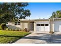 Inviting single-story home with a lush green lawn and a double garage at 7122 11Th W Ave, Bradenton, FL 34209