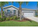 Charming home exterior with stone accents, a tidy lawn, and manicured landscaping for a polished and inviting look at 13804 Camden Crest Ter, Lakewood Ranch, FL 34211