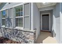 Inviting front entrance with decorative stone accents and a 'Welcome' mat for a warm and friendly greeting at 13804 Camden Crest Ter, Lakewood Ranch, FL 34211