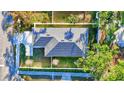 Overhead view of the house showcasing its roof, manicured lawn, and surrounding fence at 1422 19Th St, Sarasota, FL 34234