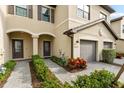 Charming home exterior showcasing a gray brick driveway, manicured landscaping, and covered entryway at 15225 Lyla Ter, Bradenton, FL 34211