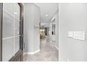 Bright foyer with tile flooring, neutral walls, and view into the open-concept living area at 15225 Lyla Ter, Bradenton, FL 34211