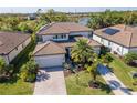 Beautiful home with solar panels, tile roof, paver driveway, lush landscaping, and a community lake view at 18013 Polo Trl, Bradenton, FL 34211