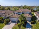 Beautiful two-story home boasting a tile roof, two-car garage, and lush landscaping in a desirable neighborhood at 18013 Polo Trl, Bradenton, FL 34211