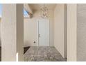 Welcoming front entrance with a modern light fixture and tiled flooring at 2364 Carpenter Ln, North Port, FL 34286