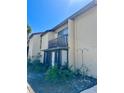 Exterior of two-story condo unit with a balcony and manicured shrubs at 2632 Hidden Lake N Dr # E, Sarasota, FL 34237