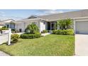 This home features vibrant landscaping, lush green lawns, and meticulous shrubbery surrounding the front of the property at 2908 Fiddlers Bnd, Palmetto, FL 34221