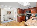 Spacious kitchen with updated appliances and granite countertops and a view to adjacent dining area at 3289 Fairhaven Ln # 112, Sarasota, FL 34239