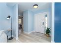 Bright foyer with wood-look floors, showing a view of the front door and a bedroom entry at 3910 Cape Haze Dr, Rotonda West, FL 33947