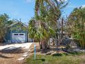 Lovely home featuring mature landscaping, a fenced yard, and a tranquil outdoor ambiance at 402 71St St, Holmes Beach, FL 34217