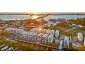 Stunning aerial view of waterfront property showcasing multiple homes with boat docks and sunset backdrop at 4305 Marina View Way, Cortez, FL 34215