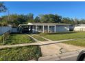 Inviting single-story home with a covered carport and a driveway at 4431 W Wallace Ave, Tampa, FL 33611