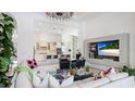 Bright living room with open floor plan leading to the kitchen, featuring stylish decor and modern entertainment center at 4706 Balboa Park Loop, Bradenton, FL 34211
