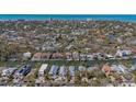 Wide angle aerial view of a waterfront property near a neighborhood of homes and canal at 4922 Commonwealth Dr, Sarasota, FL 34242