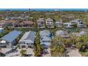 Aerial view of a waterfront property with a metal roof near canals and other residences at 4922 Commonwealth Dr, Sarasota, FL 34242