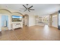Open-concept living room boasts tile floors, a ceiling fan, and seamless flow to the kitchen area at 5319 Levi Ln, Sarasota, FL 34233