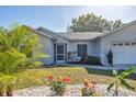 Up close exterior showcasing the home's well-maintained front yard with garden at 5330 Alseir Rd, North Port, FL 34288