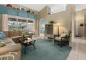 Cozy living room featuring tile floors, comfortable furnishings, and view of the outdoor patio and pool at 555 Park Estates Sq, Venice, FL 34293